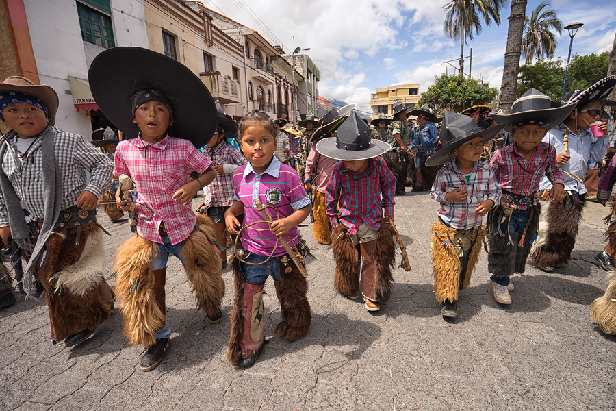 Children wearing sombreros and chaps at the Inti Raymi celebrations