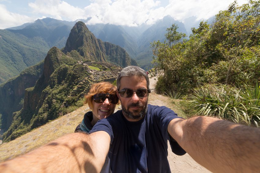 Couple taking selfie on the terraces above Machu Picchu the most visited travel destination in Peru.